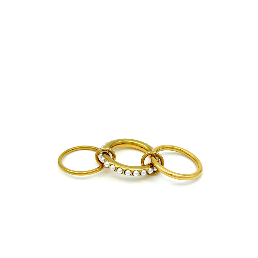 
                  
                    Anello in acciaio inox e Ottone, dorato composto da due fedi sottili,ed una spessa, tenute insieme da due anellini Oro, tono su tono.Nichel nei termini di legge. Si può indossare anche a più dita insieme. e perline sulla superfice. foto anello steso
                  
                